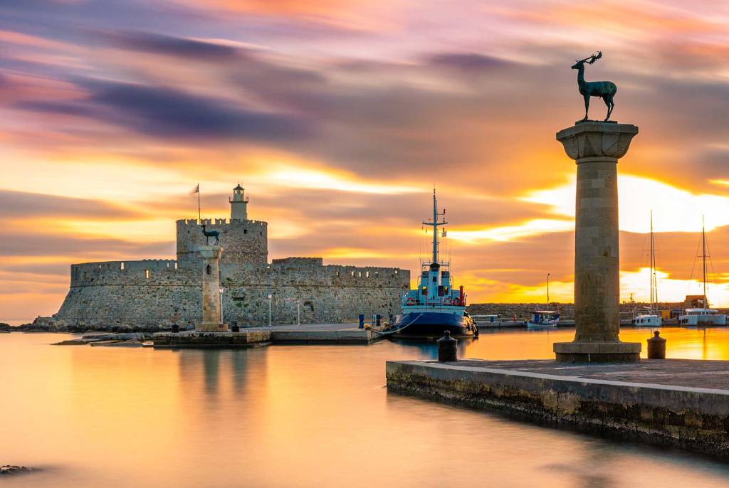 Sunset view of Mandraki Harbor in Rhodes.