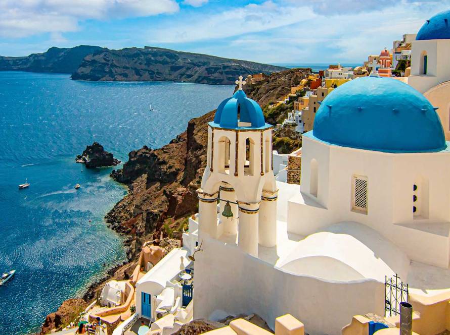 The picturesque Oia Village and Cycladic Churches on the Island of Santorini.