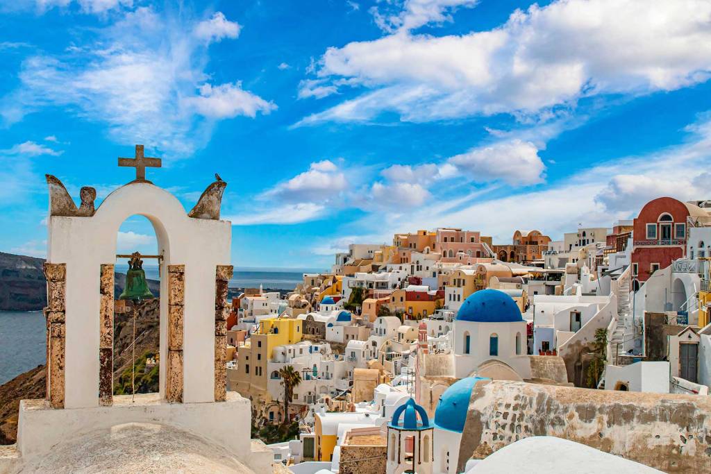 The picturesque white-washed building and Greek Churches in Oia Village, Santorini.
