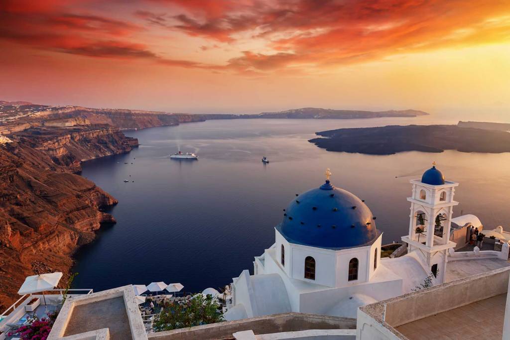 A romantic sunset in Santorini from a Greek Church.