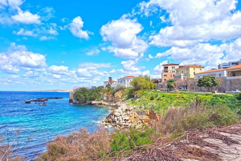 A park and picturesque houses by the sea.