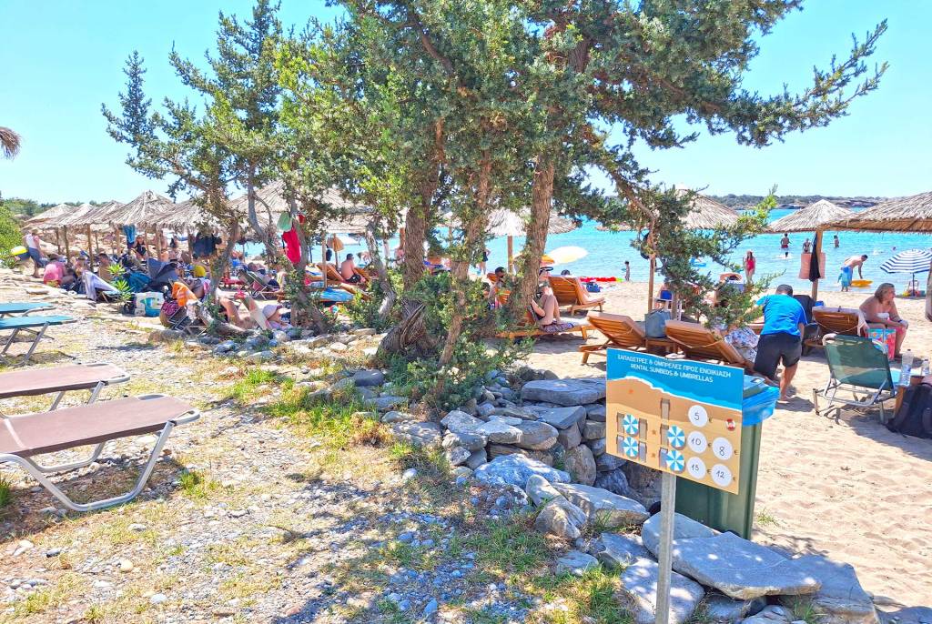 The organized Grammeno Beach, outside Houmas, offers sunbeds and umbrellas next to the trees.