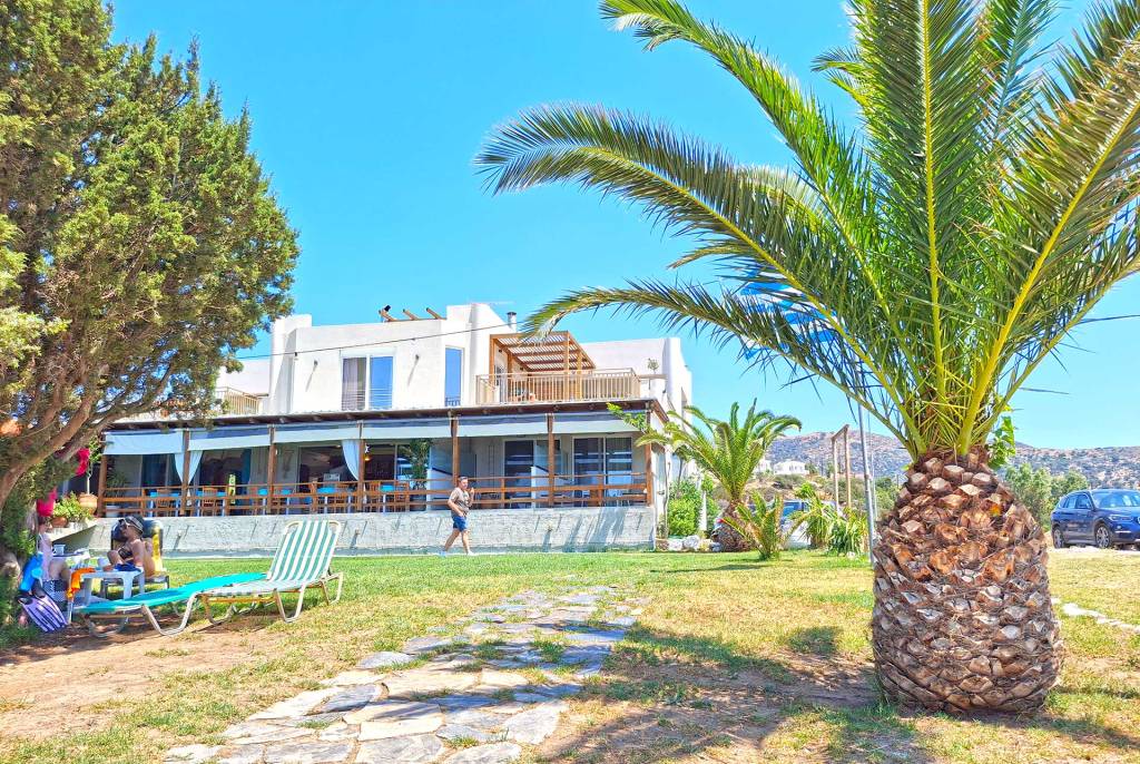 The exterior of Houmas Restaurant surrounded by trees, next to Grammeno Beach.