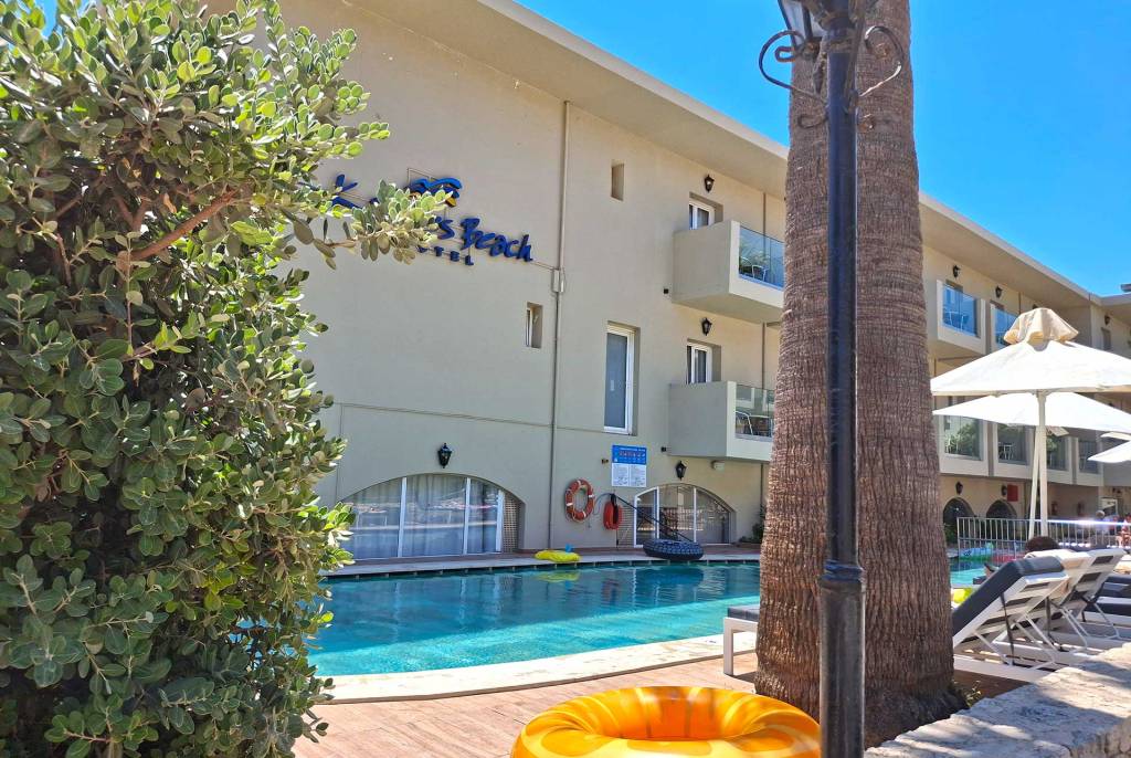 The swimming pool area with sunbeds of Kalyves Beach Hotel in Chania.