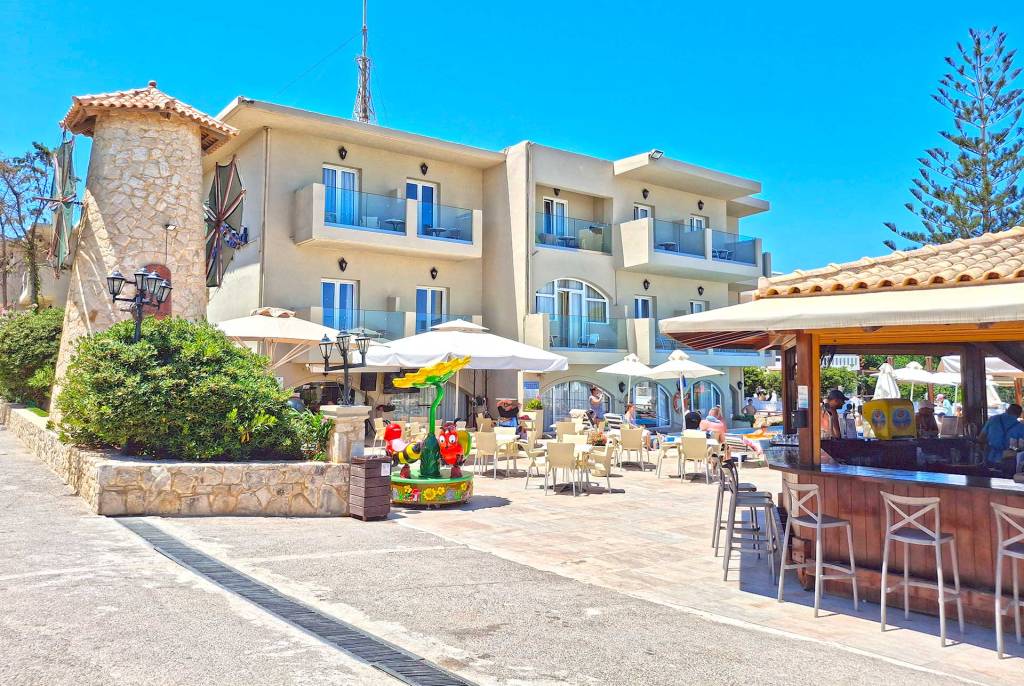 The windmill, the building, and the pool bar of Kalyves Beach Hotel in Chania.