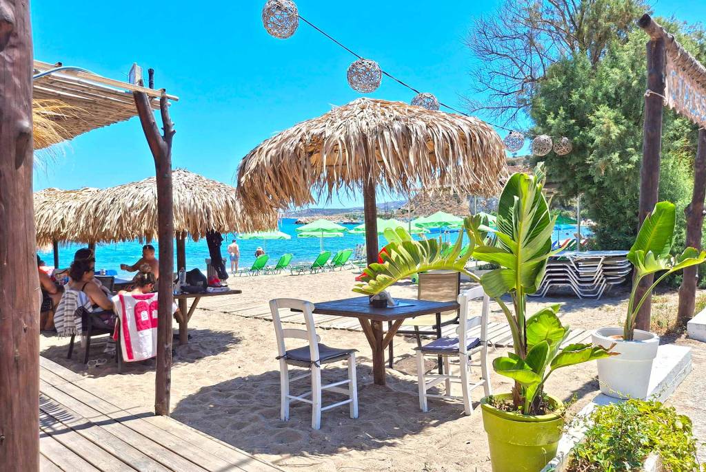 Tables, chairs, and umbrellas by the beach in Kalyves Village.