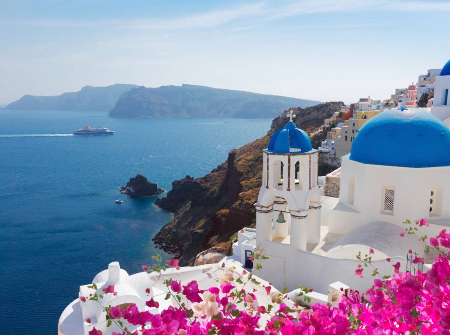 The island of Santorini, Caldera, and a ferry crossing the sea.