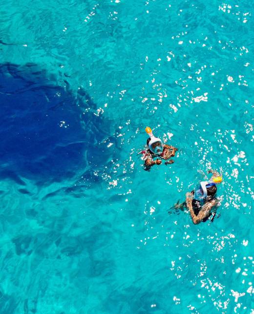 Two people are enjoying snorkeling in the waters of Chania.