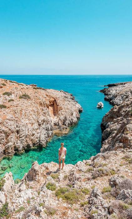 A woman gazes at the beautiful sea after crossing Avlaki Gorge.