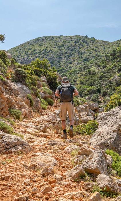 A tourist hikes through Stavros to reach Avlaki Gorge.