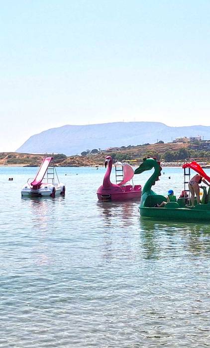 Family waterbikes in the sea of Chrissi Akti Beach, in Chania.