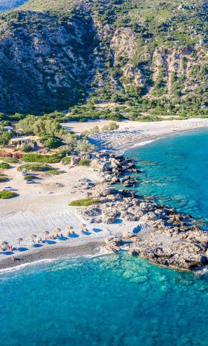 Sunbeds and umbrellas in Gialiskari Beach.