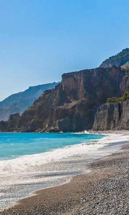 Rocky cliffs above the coast of Domata Beach.