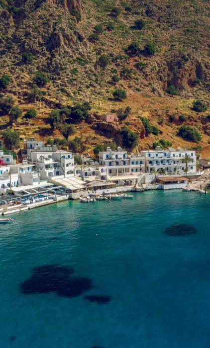 A small boat approaches Loutro Beach.