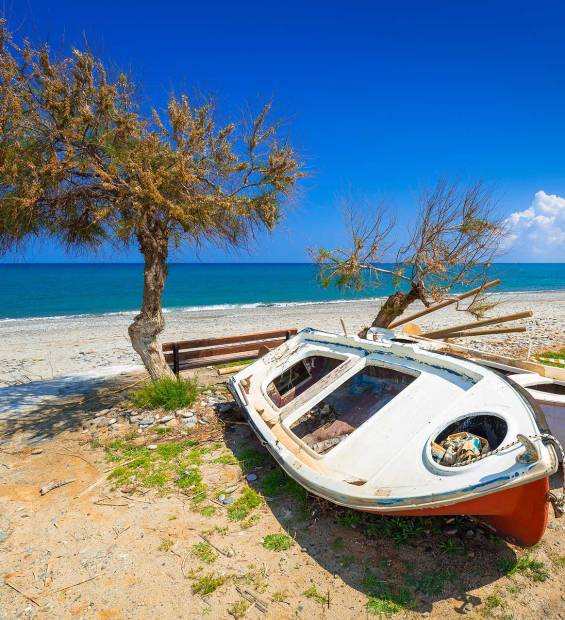 A fishing boat on the sand of Maleme Beach.