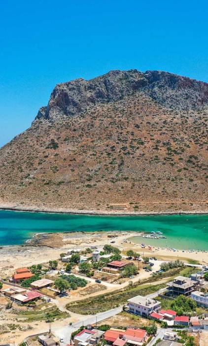 Traditional houses, apartments, the mountain, and Stavros Beach.